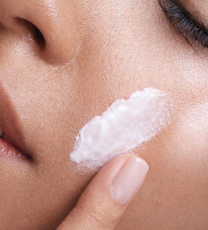Applying skincare on cheek